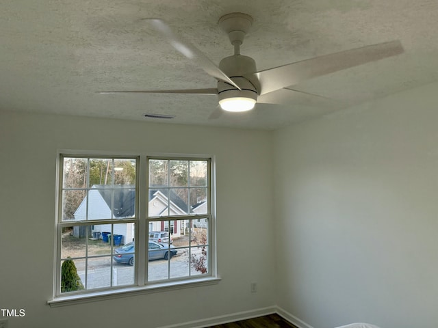 2816 Smoke Pl, Raleigh, NC 27610 - unfurnished room featuring dark wood-style flooring, ceiling fan, and a textured ceiling