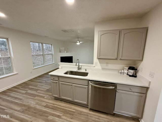 2816 Smoke Pl, Raleigh, NC 27610 - kitchen with dishwasher, gray cabinetry, a ceiling fan, light wood-type flooring, and light countertops