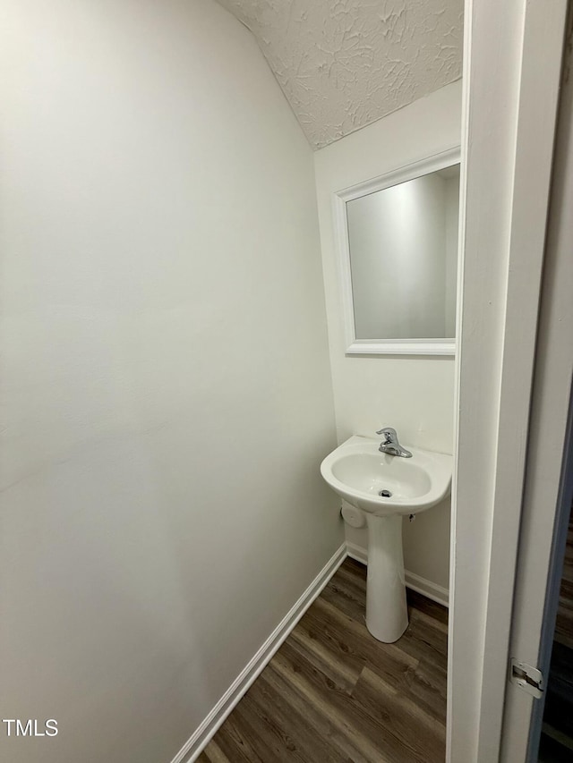 2816 Smoke Pl, Raleigh, NC 27610 - bathroom featuring wood finished floors, a textured ceiling, and lofted ceiling