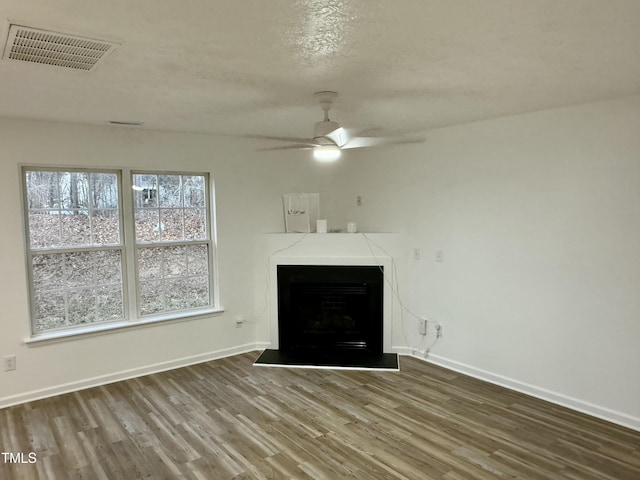 unfurnished living room with ceiling fan and hardwood / wood-style flooring