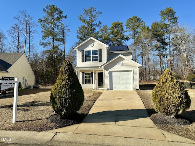 2816 Smoke Pl, Raleigh, NC 27610 - traditional home featuring roof mounted solar panels, driveway, an attached garage, and a porch