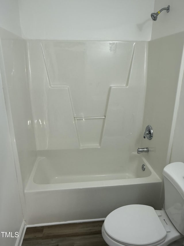 bathroom featuring toilet, shower / tub combination, and wood-type flooring