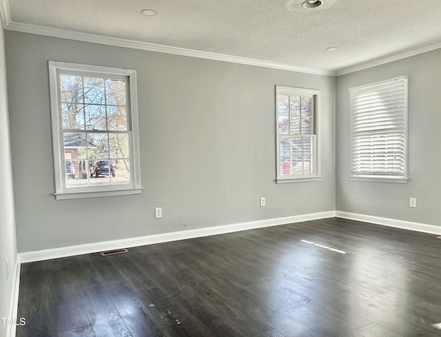 unfurnished room with a textured ceiling, dark wood-type flooring, and a healthy amount of sunlight