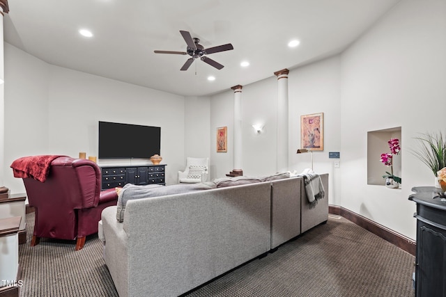 living room featuring carpet, ceiling fan, and decorative columns