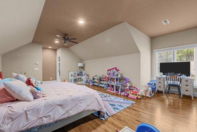 bedroom with ceiling fan, wood-type flooring, and vaulted ceiling