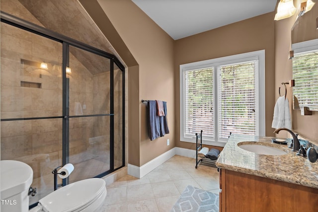 bathroom with tile patterned floors, vanity, a shower with shower door, and toilet