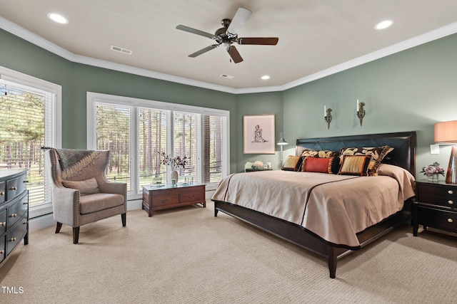 carpeted bedroom featuring ceiling fan and crown molding