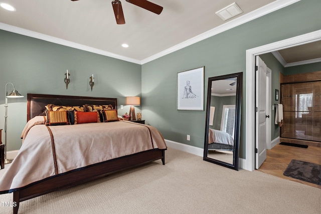 carpeted bedroom featuring ceiling fan and crown molding