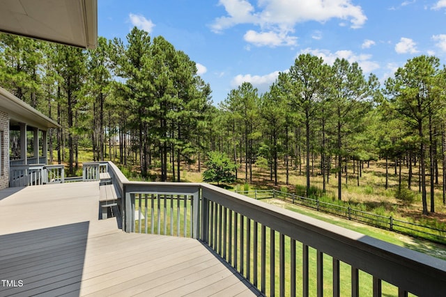 wooden deck featuring a lawn