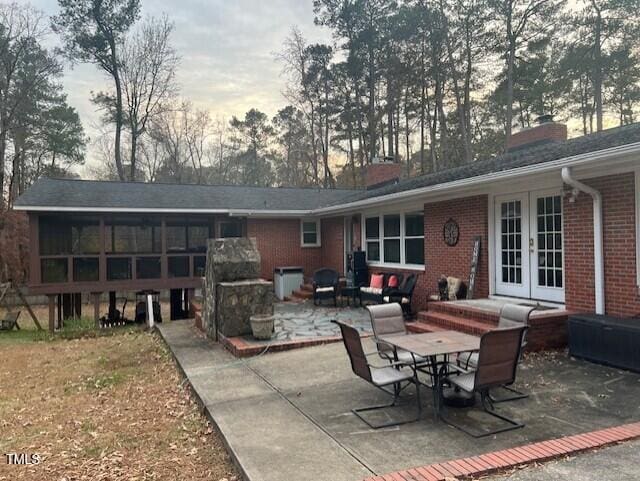 back of house with french doors and a patio