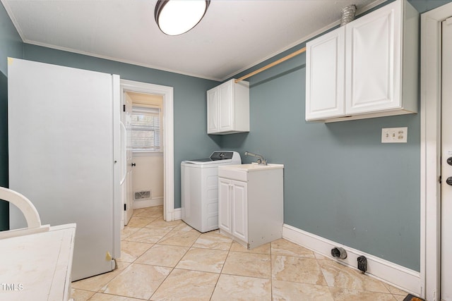 washroom with cabinets, ornamental molding, washer / clothes dryer, and sink