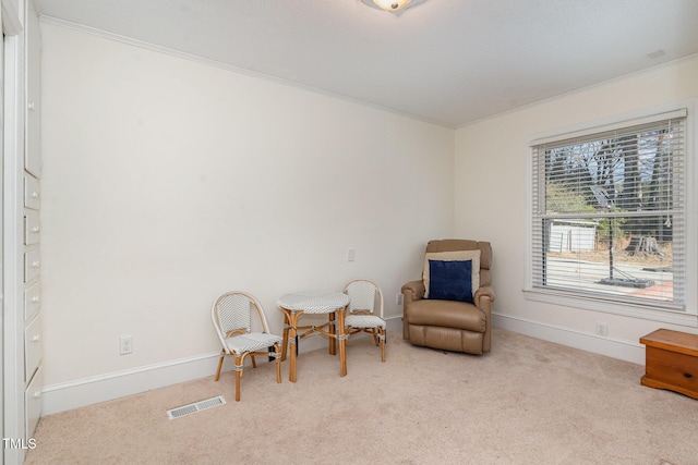 living area with light colored carpet and crown molding