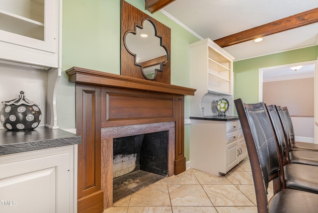 interior space featuring ornamental molding and beamed ceiling