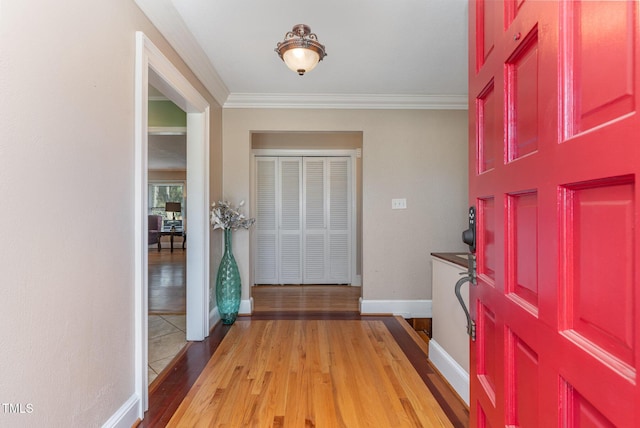 entrance foyer featuring light wood-type flooring and ornamental molding