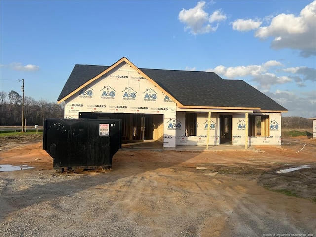 property under construction with roof with shingles