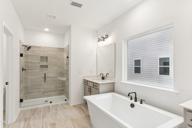 bathroom with recessed lighting, vanity, visible vents, a freestanding bath, and a shower stall