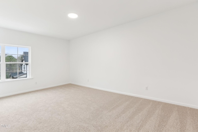 carpeted spare room with baseboards