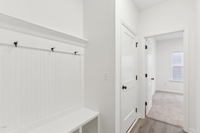 mudroom featuring light wood-type flooring and baseboards