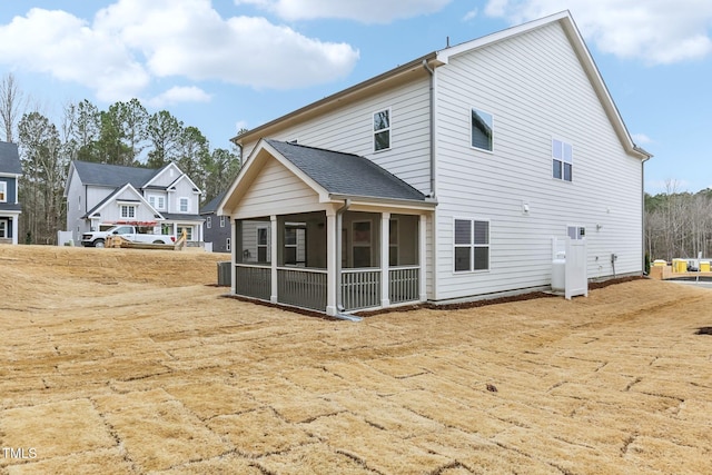 back of property with cooling unit and a sunroom