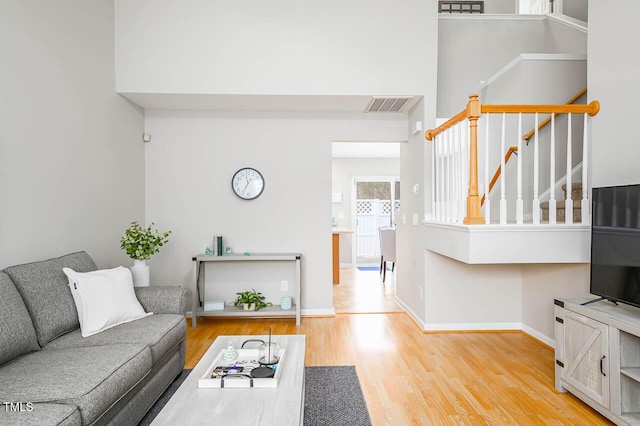 living room featuring hardwood / wood-style floors and a high ceiling