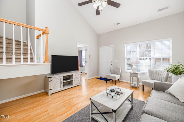 living room featuring ceiling fan, hardwood / wood-style floors, and high vaulted ceiling