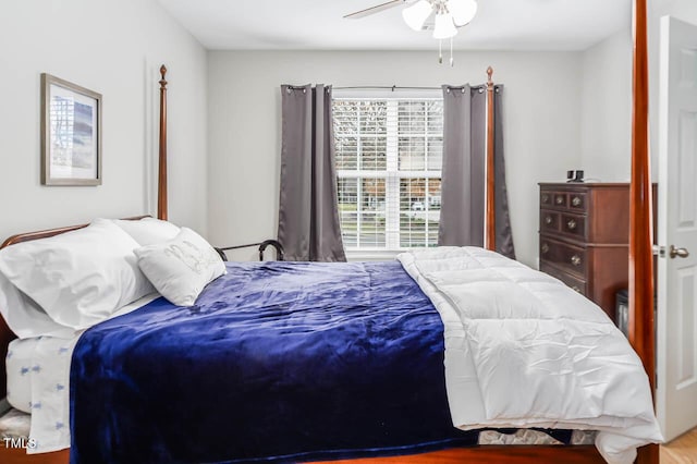 bedroom with ceiling fan and wood-type flooring