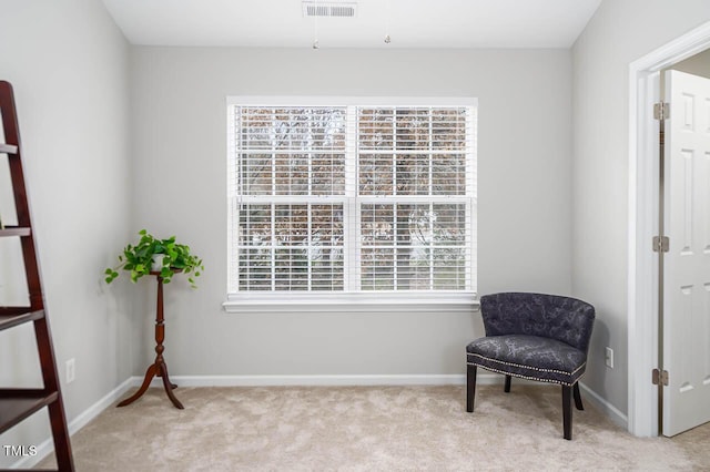 sitting room with light colored carpet