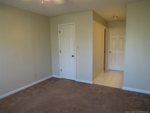 unfurnished room featuring light carpet