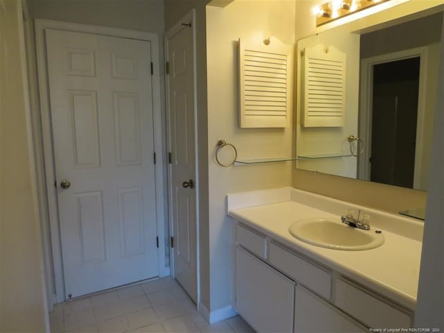 bathroom with tile patterned floors and vanity