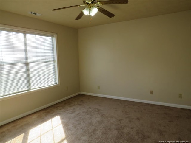 spare room featuring ceiling fan and light colored carpet