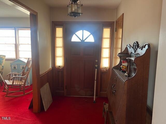 view of carpeted foyer