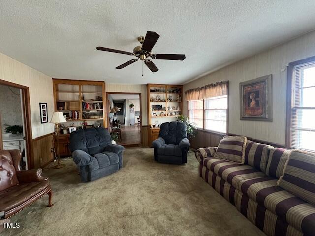 living room with a textured ceiling and a healthy amount of sunlight