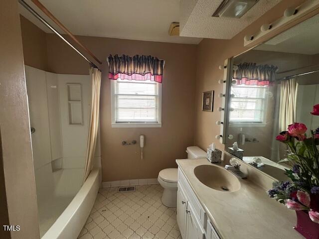 full bathroom with toilet, vanity, and shower / bath combo with shower curtain