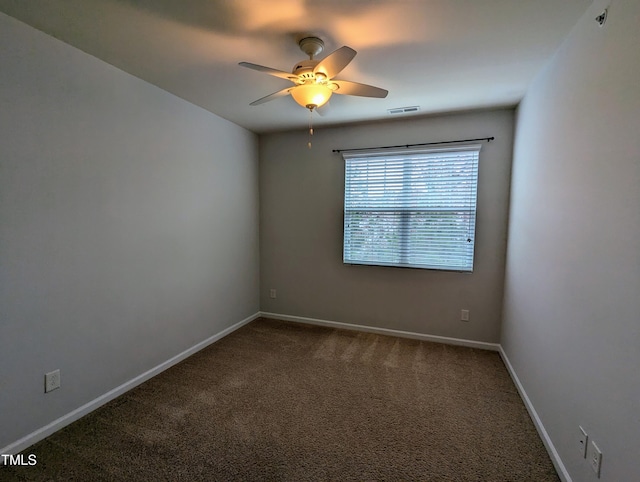 spare room with carpet and ceiling fan