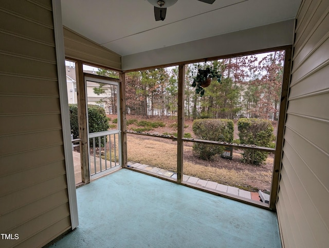 unfurnished sunroom with ceiling fan and lofted ceiling