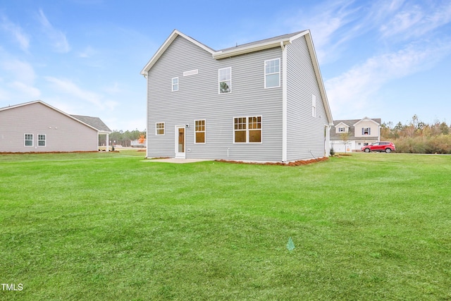 rear view of property featuring a yard