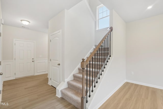 stairs with hardwood / wood-style floors