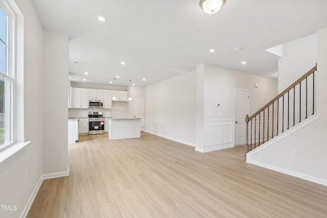 unfurnished living room with light hardwood / wood-style flooring