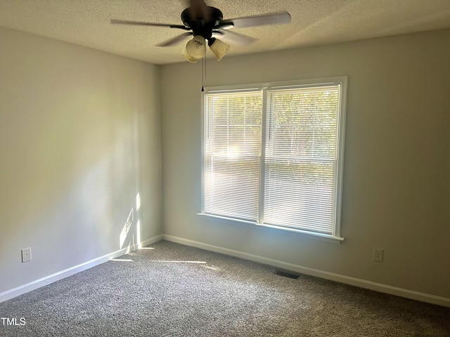 unfurnished room featuring ceiling fan, carpet flooring, and a textured ceiling