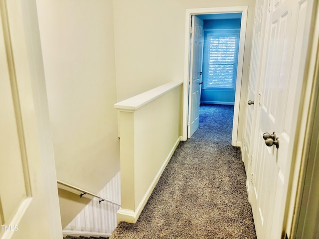 corridor with dark colored carpet