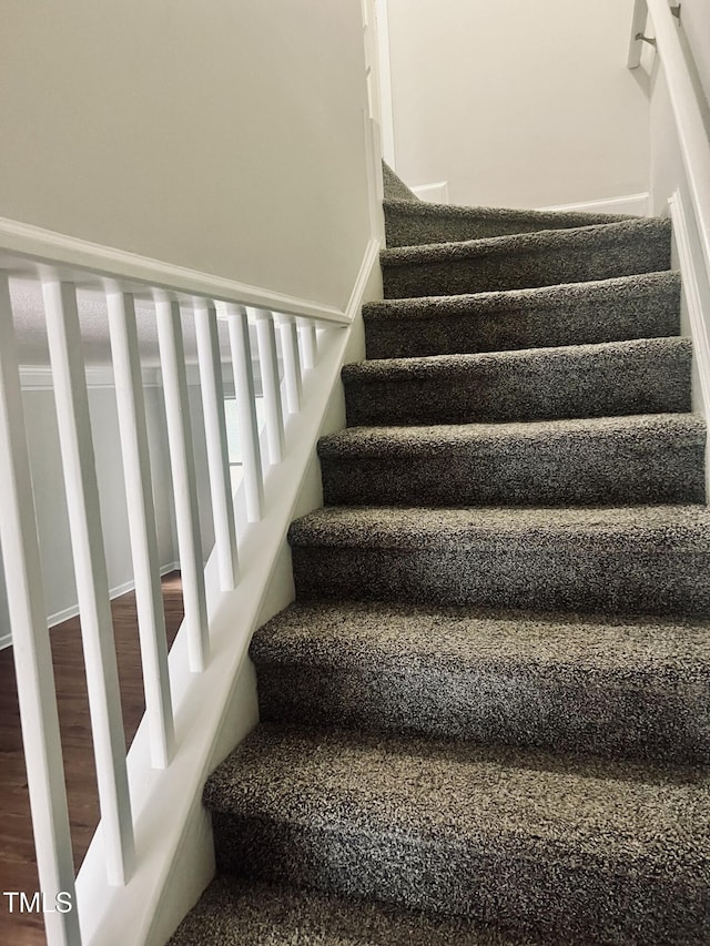 stairs featuring hardwood / wood-style flooring