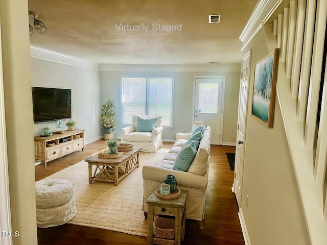 living room featuring ornamental molding, dark hardwood / wood-style floors, and a textured ceiling