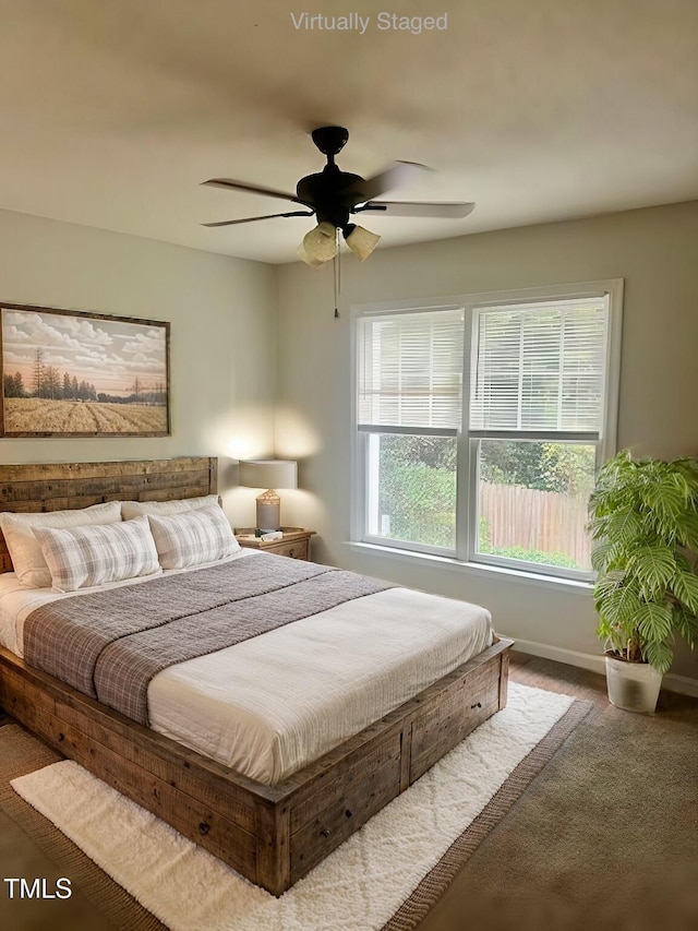 bedroom with dark carpet and ceiling fan