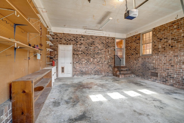 garage featuring a garage door opener and a workshop area