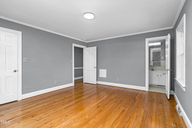 unfurnished bedroom with connected bathroom, crown molding, and light hardwood / wood-style floors