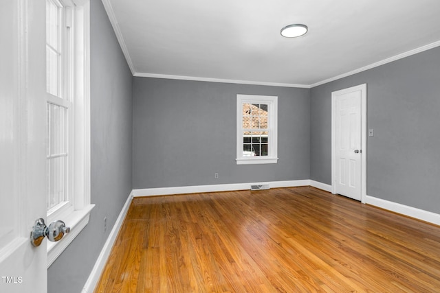 unfurnished room featuring hardwood / wood-style flooring and ornamental molding