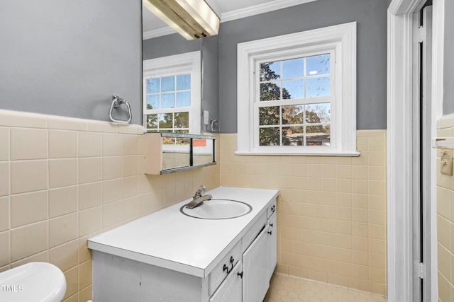 bathroom with vanity, ornamental molding, tile walls, and toilet