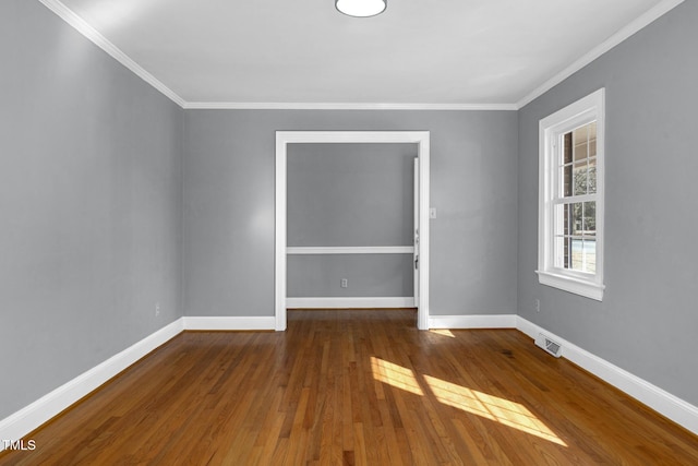 unfurnished room with crown molding and hardwood / wood-style floors