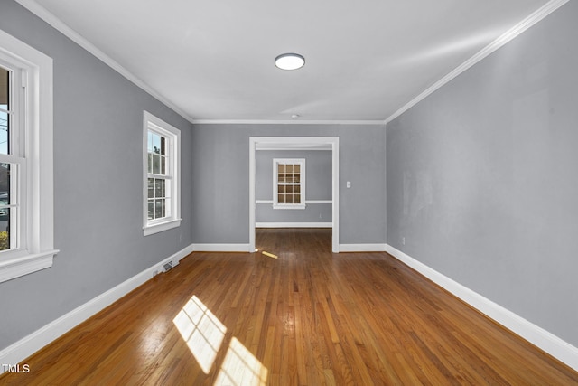 unfurnished room featuring hardwood / wood-style floors and ornamental molding