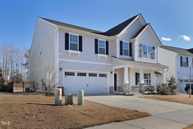 view of front of home with covered porch, cooling unit, and a garage